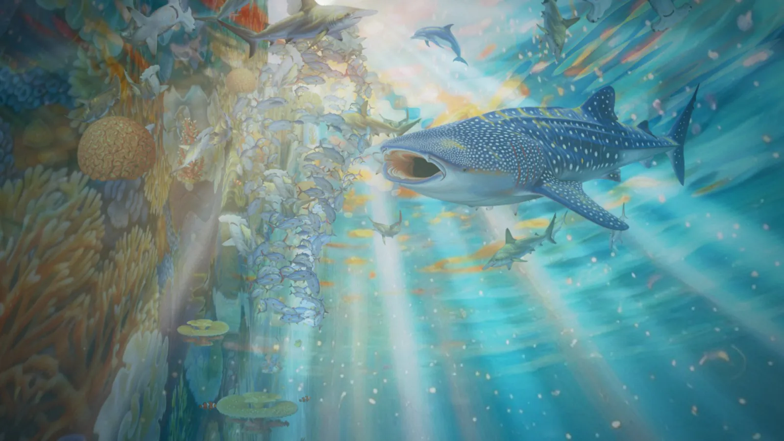 A whale shark glides through sunbeams beside a coral wall.